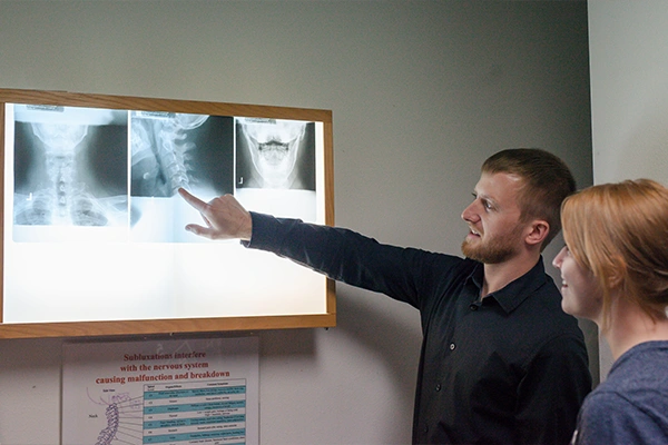 Chiropractor Oconto WI Jacob Bloch Pointing To XRays