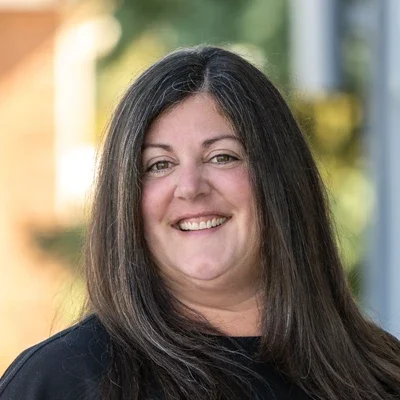 A headshot photo of Andrea