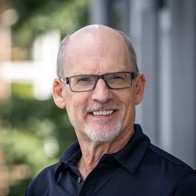 A headshot photo of Greg